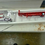 Red diecast dump truck with detailed side body and wheel