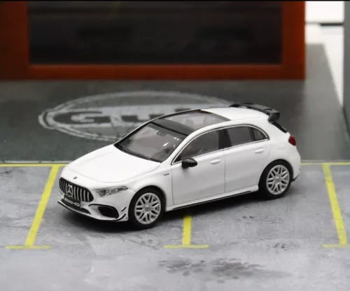 White 1:64 diecast hatchback car model, front 3/4 view with black grille