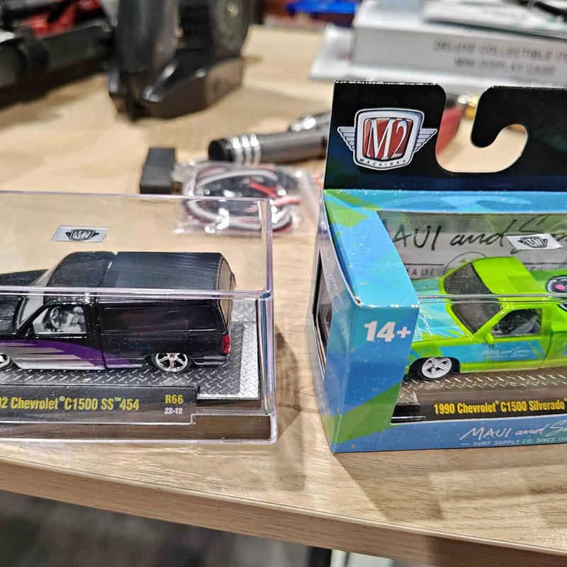 Diecast pickup truck model in display box, black interior, chrome detail, lime green car
