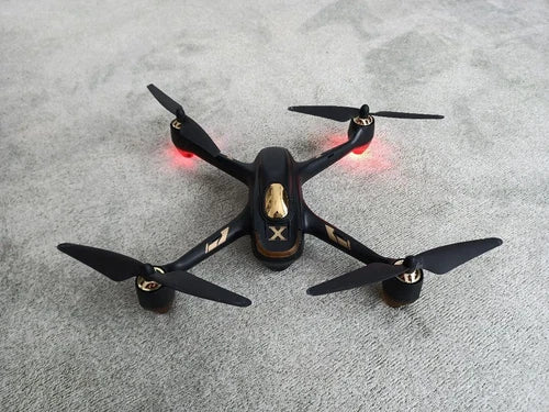 Black quadcopter drone with four propellers and front camera housing