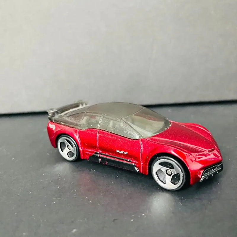 Red diecast sports car with dark hood, detailed wheels and headlights