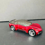 Red diecast sports car with dark hood, detailed wheels and headlights