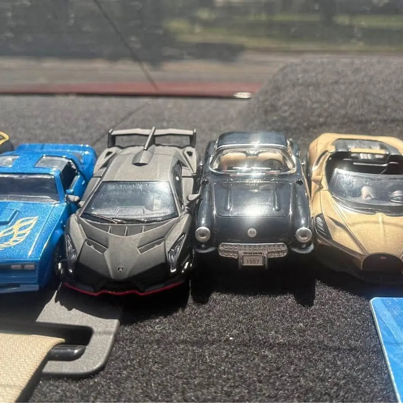 Set of diecast toy cars, including blue, black, silver, and tan models