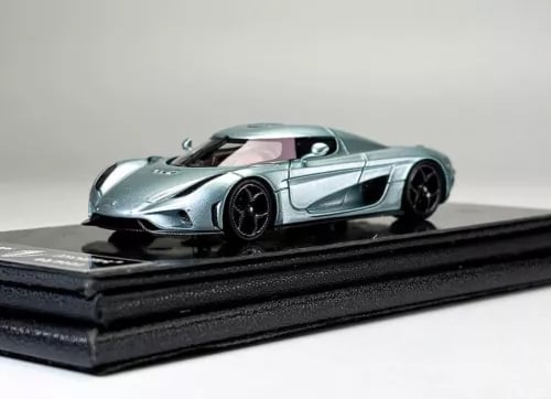 Ice blue diecast racing car model on black display base, front-left view