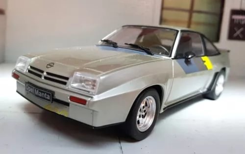 Silver 1981 model coupe diecast car, front 3/4 view with black hood and grille detail