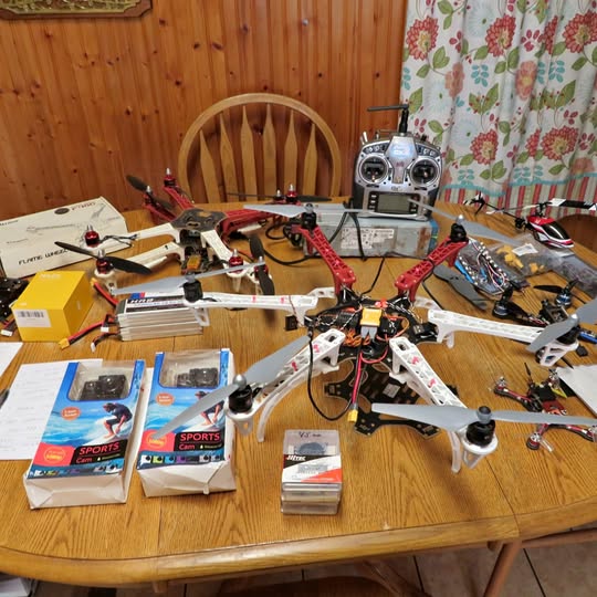 Drone set with multiple quadcopter frames and controllers on a table