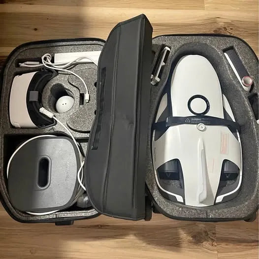 Hard-shell drone carrying case with foam inserts, controller and white device inside