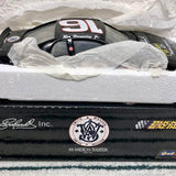 1/24 scale diecast race car, black with sponsor decals and checkered graphics