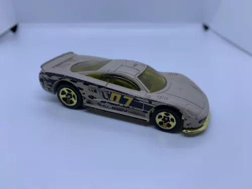 Grey diecast model car with green hood and yellow star wheels