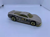 Grey diecast model car with green hood and yellow star wheels