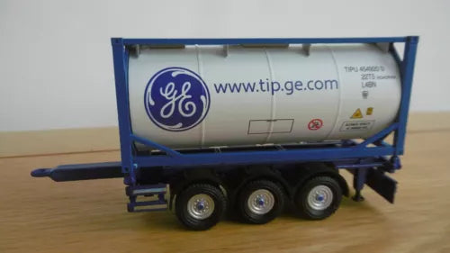 Blue tank container trailer with GE logo, three-axle wheels, and drawbar linkage
