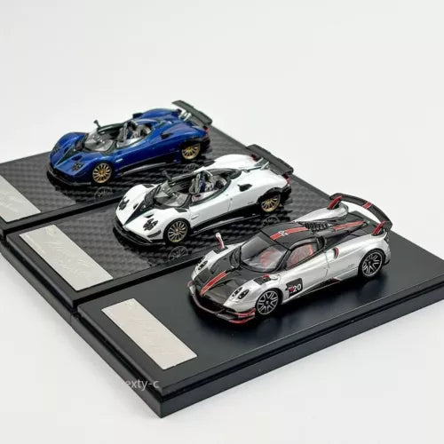 Die-cast sports car models set, three metallic cars on black display base