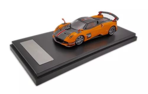 1:64 orange diecast roadster model car on black display base