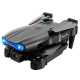 Gray folding quadcopter drone with blue LED lights and front camera, detachable arms
