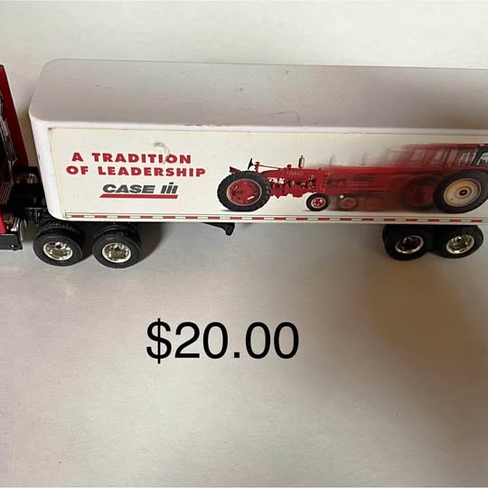 Diecast semi tractor trailer toy with white box and red Case logo, multiple wheels