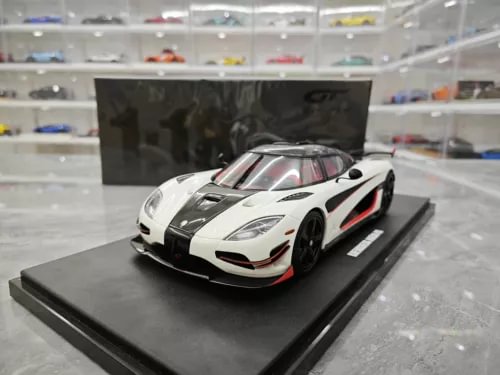 White Koenigsegg Agera RS diecast car model with black stripe and red detailing