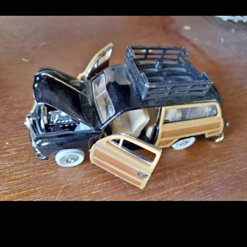 Vintage diecast wagon car with open rear and blue cargo rack
