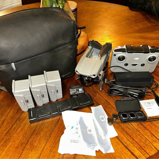 Drone kit with Mavic-style drone, controller, batteries, cables, and protective bag