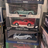 Diecast model car set in display boxes with teal, red, and white cars