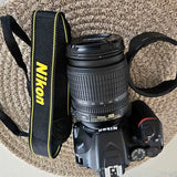 Nikon D3500 DSLR camera with 18-105mm lens and strap