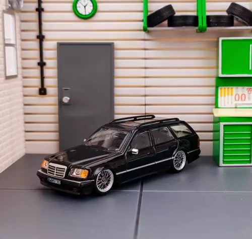 Black diecast wagon car model, front three-quarter view with detailed wheels
