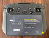 Gray drone remote controller with dual thumb controls and multiple buttons