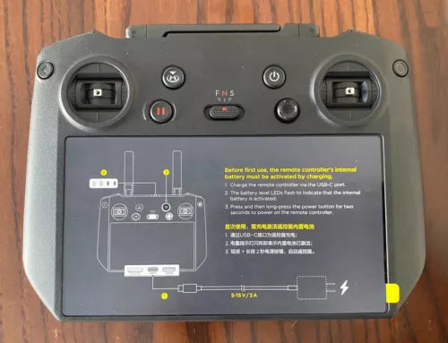 DJI RC Pro controller with dual joysticks, buttons, and status screen panel