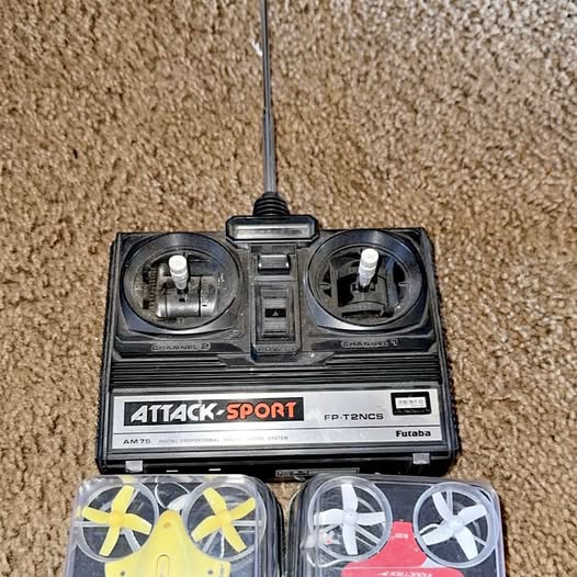 Remote control drone transmitter with antennas, two joysticks, and prop guards