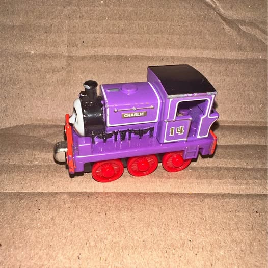 Thomas & Friends purple diecast train car with Charlie nameplate and red wheels