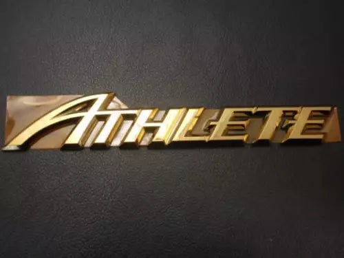 Metallic gold “HobbyElite” logo decal on dark background