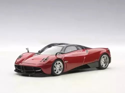 Red diecast sports car model, front-left view, black front splitter and wheels.