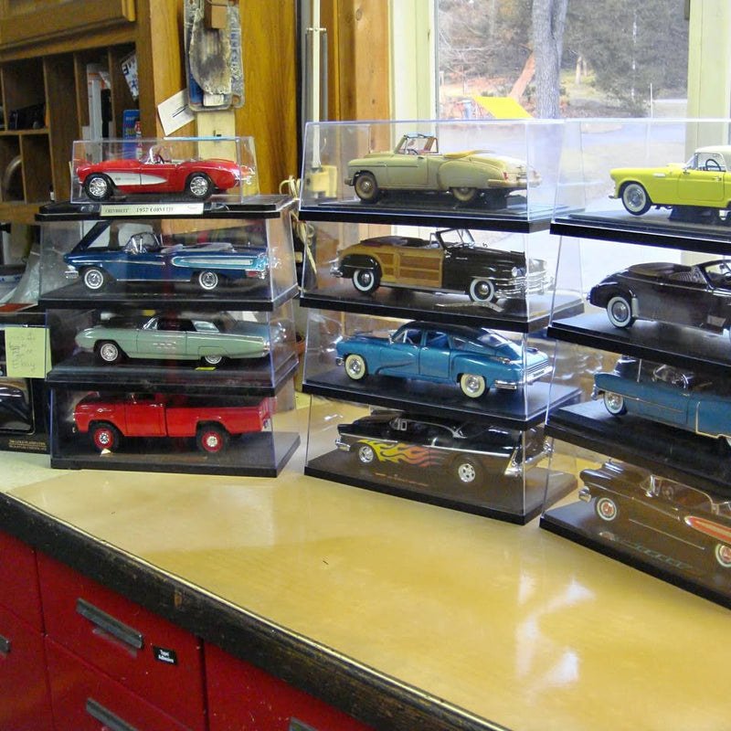 Vintage diecast cars in display cases, mixed colors and styles, assorted trucks and sedans