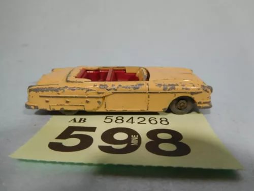 Yellow vintage diecast convertible car with black wheels