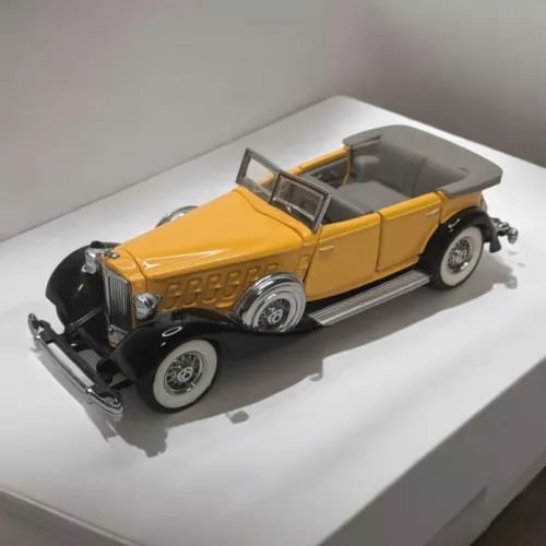 Yellow and black 1934 convertible diecast car model, 1:43 scale with open top