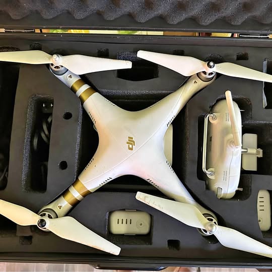 White DJI Phantom SE drone with four propellers, in its case