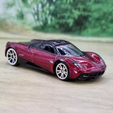Pagani Huayra 1/64 diecast model car, maroon with black wheels and clear windows.