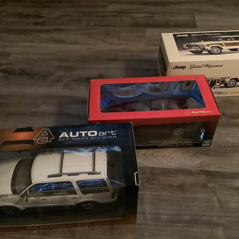 Diecast SUV model in open Autoart box with clear plastic window