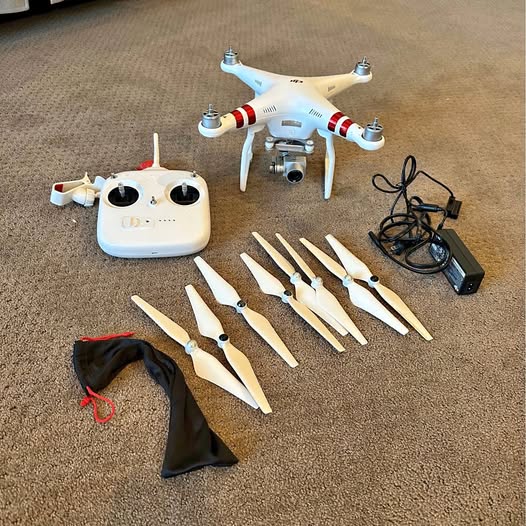 DJI Phantom 3 drone kit with controller, propellers, charger, and cables