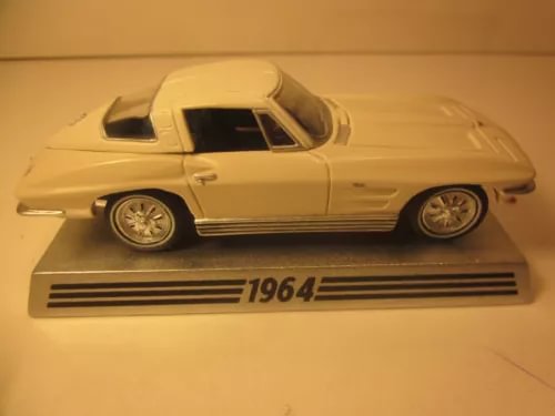 White 1964 Corvette coupe diecast model car on display base with 1964 label