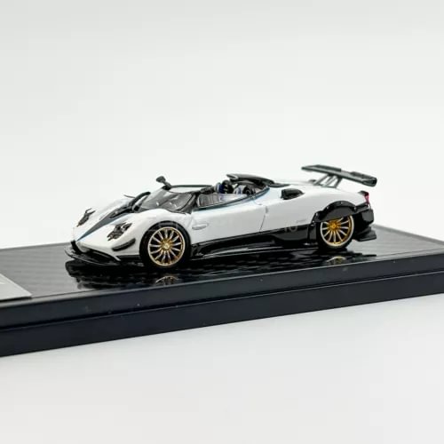 White 1:64 scale sports diecast toy car model with black rear wing and gold wheels