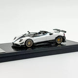 White 1:64 scale sports diecast toy car model with black rear wing and gold wheels