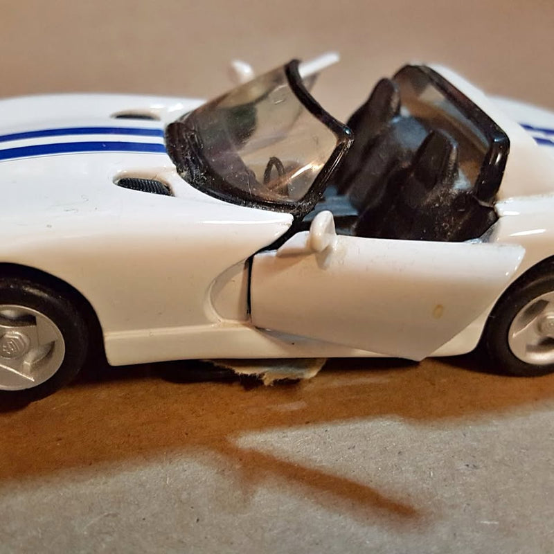 White diecast sports car with open cockpit, front side view