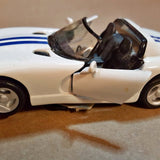 White diecast sports car with open cockpit, front side view