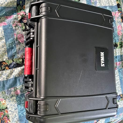 Rugged black hard-shell carry case with SYMX logo and latches