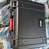 Rugged black hard-shell carry case with SYMX logo and latches