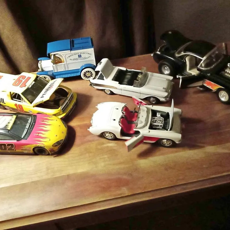Diecast car assortment with multiple vehicles, including race cars and trucks, mixed colors