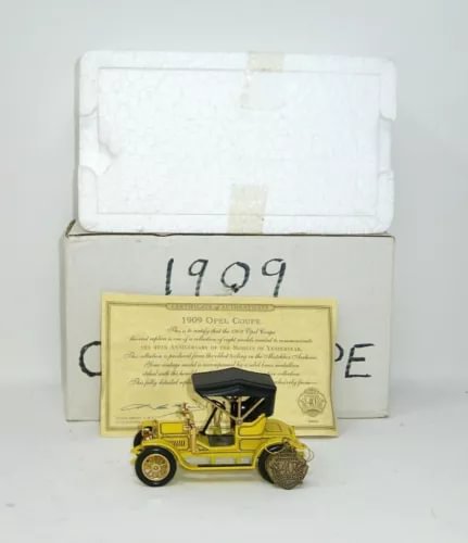 1909 Opel coupe diecast model car, yellow with black detailing, in presentation box