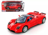 Red diecast sports car model with black aero details and white-spoke wheels