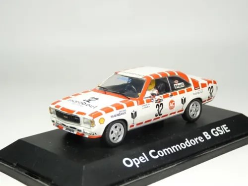 Diecast model car of an Opel Commodore B GS/E in white with orange racing stripes