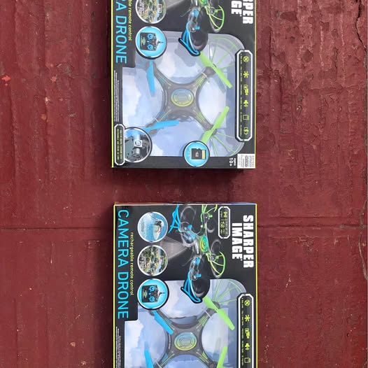 Drone toy in retail box, blue and black with green accents and camera icon